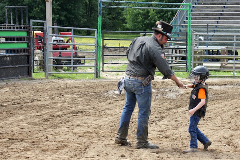 A boy saluting his mutton busting coach
