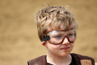 A boy wearing glasses for eye protection of mutton busting accidents