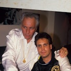 Evel Knievel posing with his son, the picture is located in a photo album