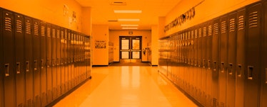 An empty school hallway with a yellow filter over it
