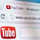 The search bar of the Safari browser with "www.youtube.com" typed in it, with the YouTube page slowl...