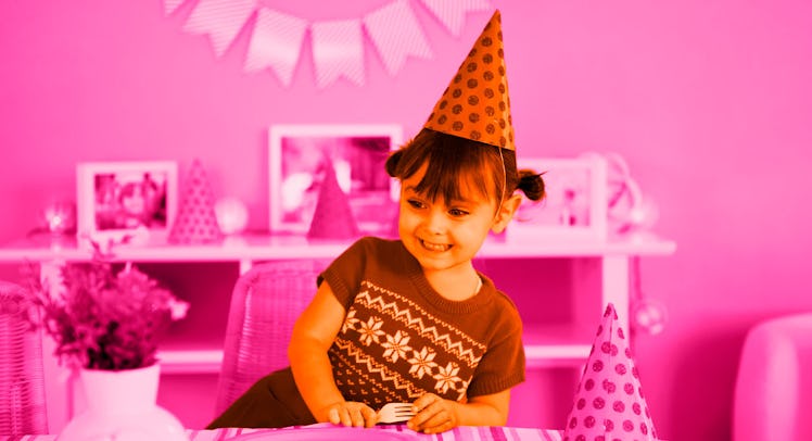 a 4-year-old birthday girl wheres a party hat against a pink background at a kids birthday party