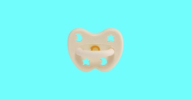 A baby pacifier set against a teal background