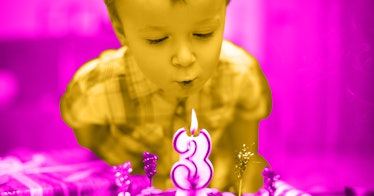 a boy at a kids birthday party blows out 3-shaped birthday candle