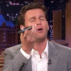 Jonathan Groff singing into a phone for jimmy fallon's kids during the tonight show