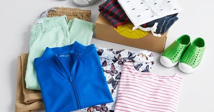 a kids clothing subscription box is open to reveal different kids clothes