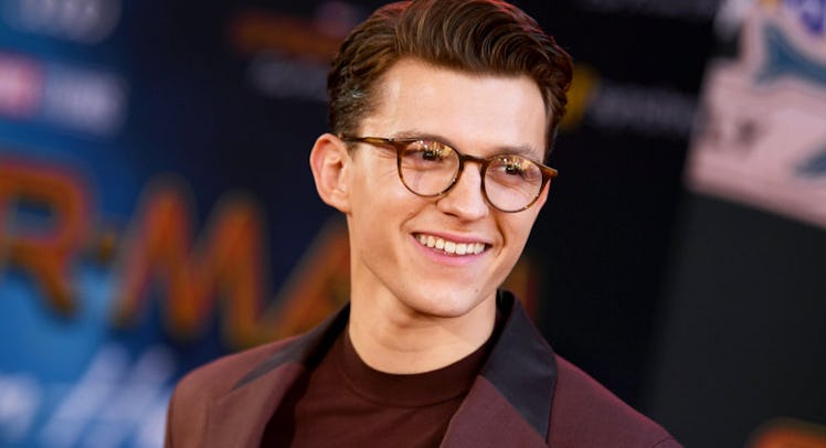Full-profiled Tom Holland in a red blazer