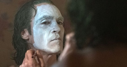 Joaquin Phoenix, in his Joker role in the movie, putting white paint on his face