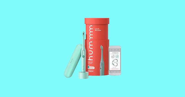 Kids' electric toothbrush set against a teal background.