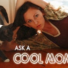A woman laying down with her cat biting on her hair with "ASK A COOL MOM" below her 