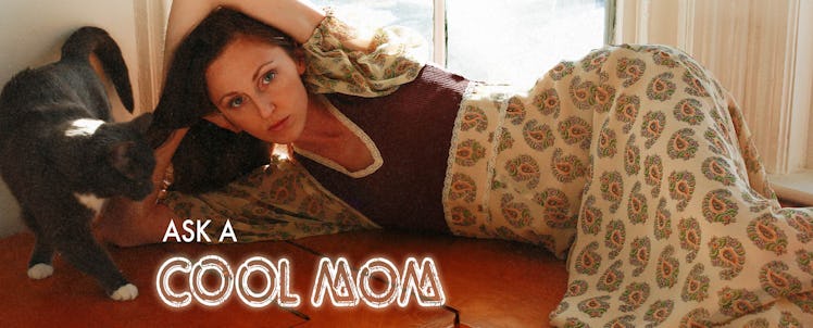 A woman laying down with her cat biting on her hair with "ASK A COOL MOM" below her