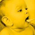 infant being fed baby probiotics with yellow shading edit