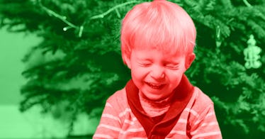 red and green photo edit of a kid laughing hard at a Christmas joke next two a Christmas tree