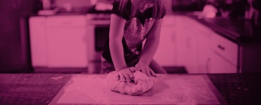 A kid who has realized her natural talent is cooking rolling up dough on a kitchen counter with a pi...