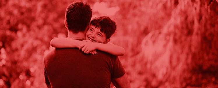 A naval officer hugging his son