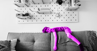 grey scale edit of a bored child laying atop a couch
