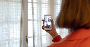 A woman on a video call with two friends during an epidemic