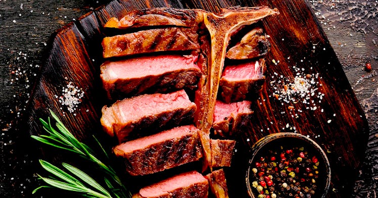 neatly sliced medium-rare T-bone steak from a meat delivery service