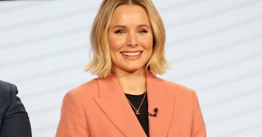 Kristen bell in a pink blazer and black shirt on a red carpet event