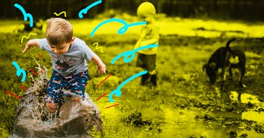 A little boy happily playing in the mud