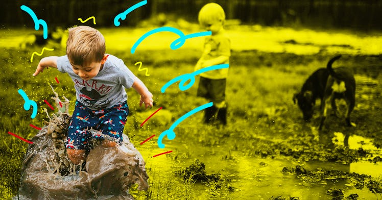 A little boy happily playing in the mud