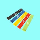 A black, blue, yellow, red, and green exercise band on a bright blue background