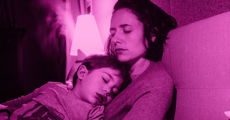 A mother and son experiencing coronavirus sleep regression, sleeping on each other on a couch