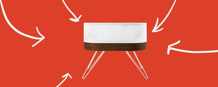 The Snoo Smart Bassinet with white arrows pointing to it