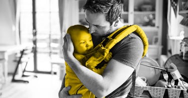 A father holding a baby in his Baby Carrier