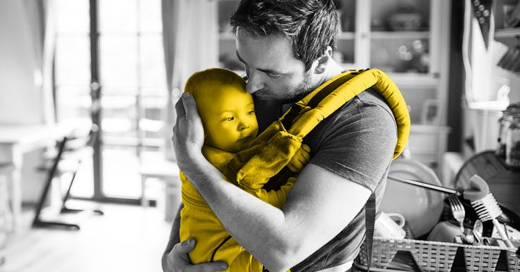 A father holding a baby in his Baby Carrier