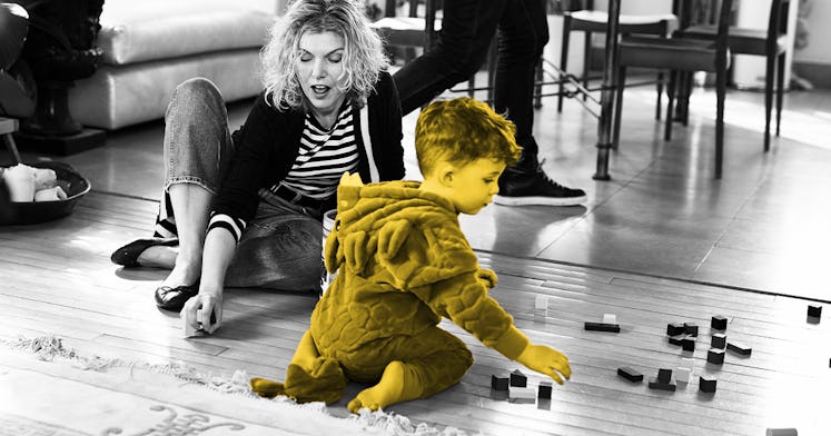 grey scale edit of a women coordinating an activity for 2 year olds with her son