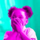 pink and green photo edit of a girl laughing hard at a birthday joke for kids
