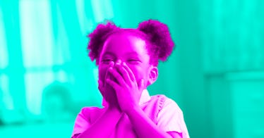 pink and green photo edit of a girl laughing hard at a birthday joke for kids