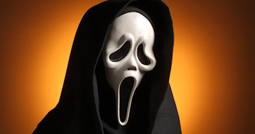 A person wearing the spooky black and white mask from the movie Scream