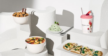 Five different meals for kids placed on various white platforms