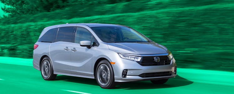 Silver 2021 Honda Odyssey driving through a tarred road