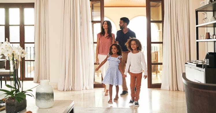 A mother, father, and their two daughters walk into a hotel