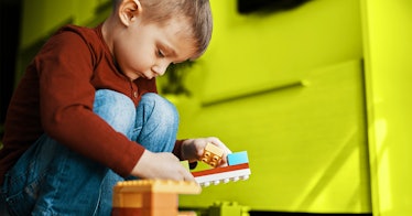 a toddler plays with Legos, a great activities for 3-year-olds