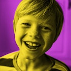 close up shot of a boy laughing at science jokes