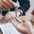 A realtor handing keys to another man after the close of a house