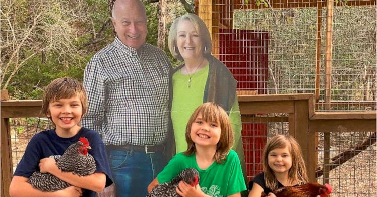 A family stands with a cardboard cutout