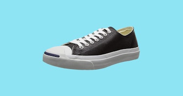 single black and white converse shoe on blue background