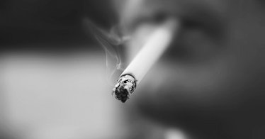 A lit cigarette in black and white