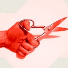 A hand with a pair of scissors representing a vasectomy
