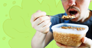 close up shot of a man holding a bowl of beans as he takes a spoonful into his mouth