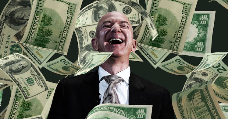 Jeff Bezos laughs in front of hundred dollar bills