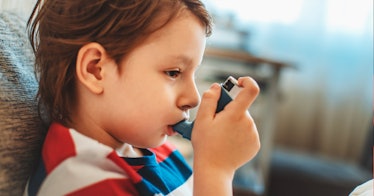 A child using an inhaler.