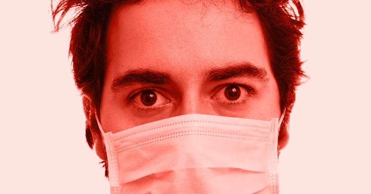 the face of a man with a mask on stares ahead