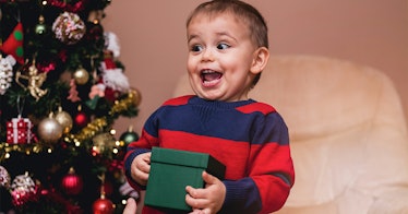 A young kid enjoys receiving a gift