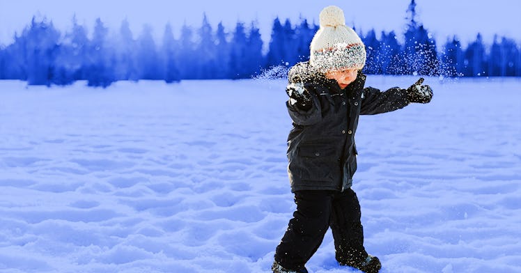 kid engaging in a winter activity in the snow